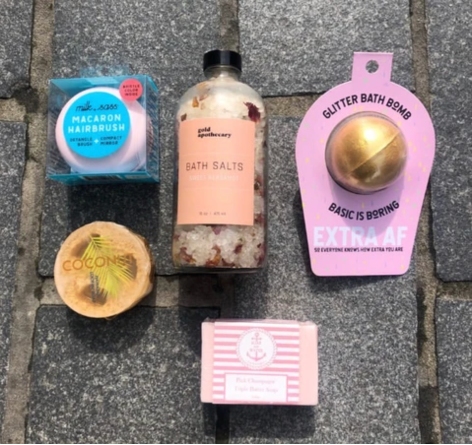 Bath themed care package with bath bomb, bath salts, hair brush, loofah soap, and bar soap from Diament Jewelry, a gift shop in Washington, DC.
