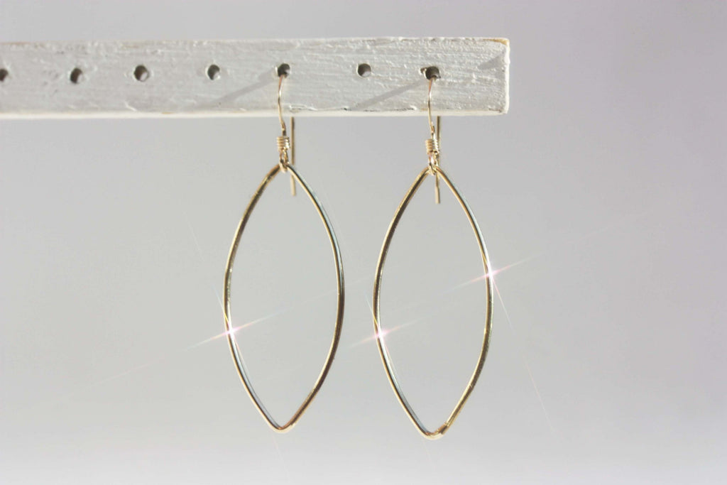 Gold oval wire dangle earrings from Diament Jewelry, a gift shop in Washington, DC.