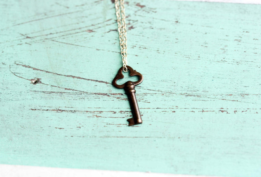 Tiny bronze key chain necklace from Diament Jewelry, a gift shop in Washington, DC.