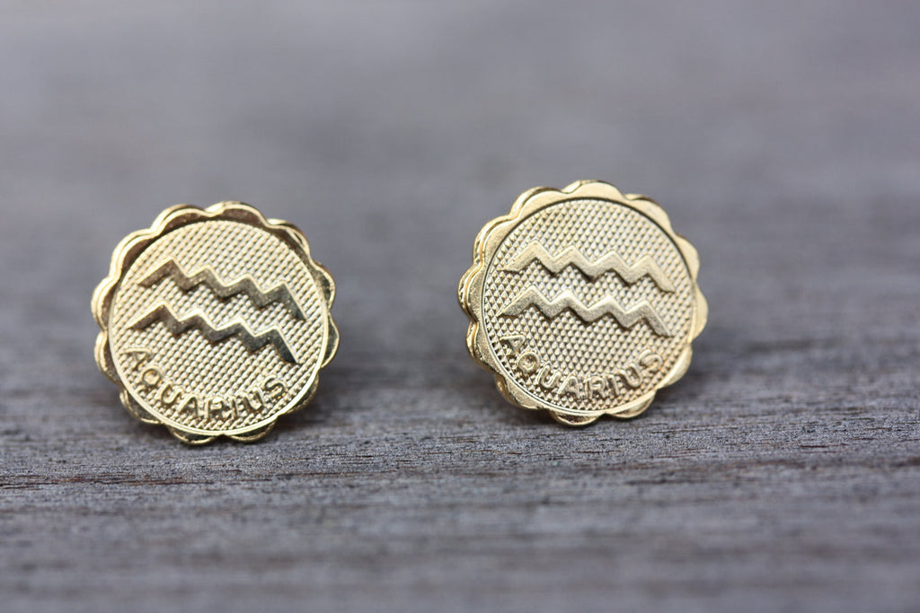 Gold Aquarius astrology studs from Diament Jewelry, a gift shop in Washington, DC.