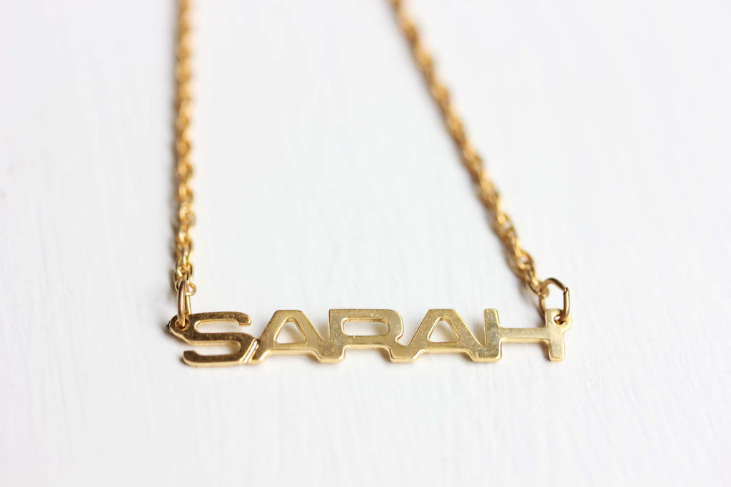 Vintage Sarah gold name necklace from Diament Jewelry, a gift shop in Washington, DC.