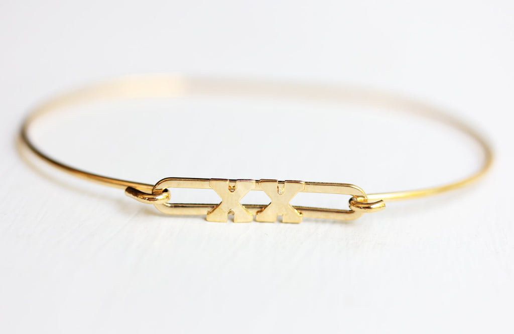 Gold XX Bracelet from Diament Jewelry, a gift shop in Washington, DC.