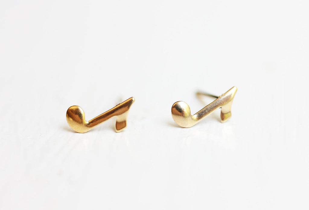 Tiny gold music note studs from Diament Jewelry, a gift shop in Washington, DC.
