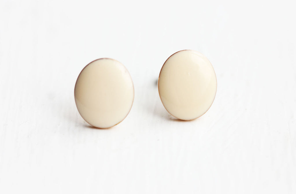 White oval stud earrings from Diament Jewelry, a gift shop in Washington, DC.