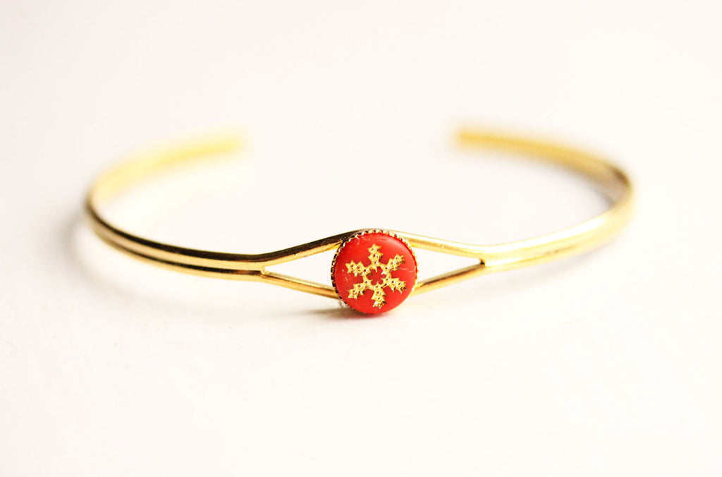 Red starburst gold cuff bracelet from Diament Jewelry, a gift shop in Washington, DC.
