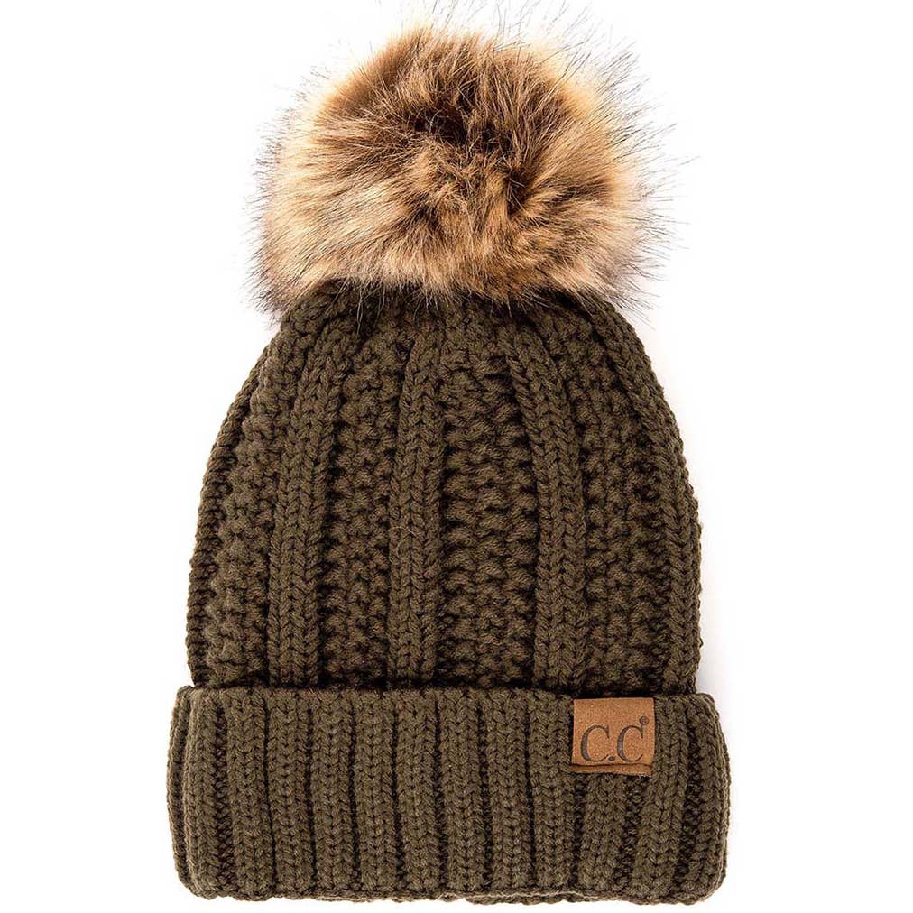 Olive Lined Cable Pom Beanie from Diament Jewelry, a gift shop in Washington, DC.