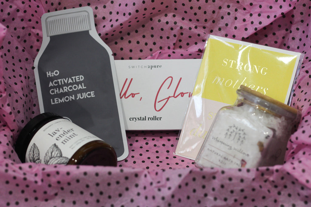  A Mother's Day care package containing a card, face mask, crystal roller, lavender mint candle, and rose bath salts from Diament Jewelry, a gift shop in Washington, DC.