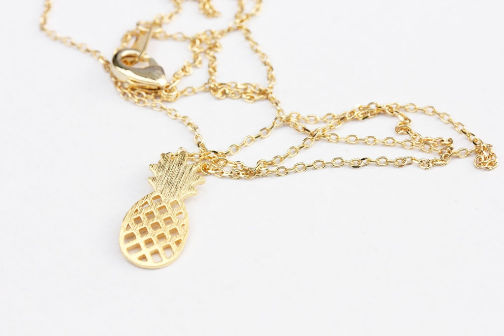 Gold pineapple charm necklace from Diament Jewelry, a gift shop in Washington, DC.