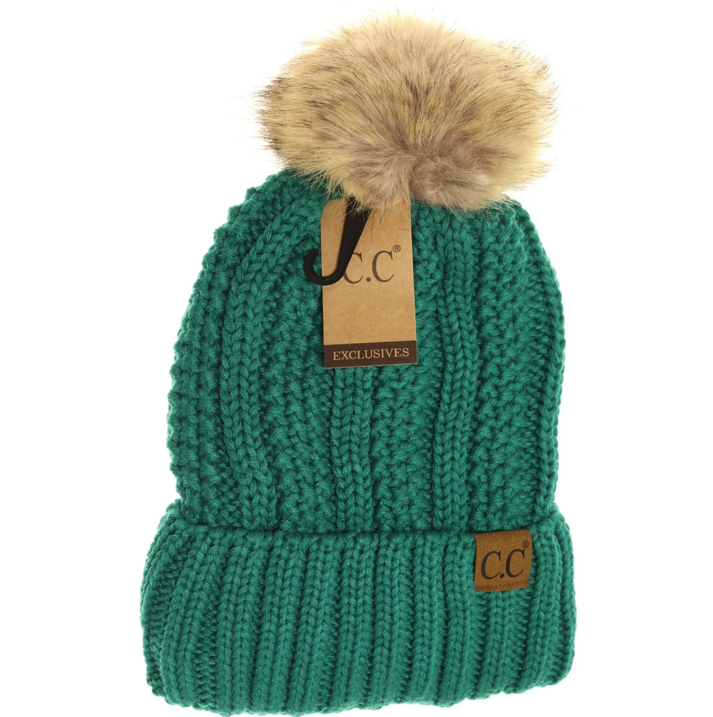 Emerald Lined Cable Pom Beanie from Diament Jewelry, a gift shop in Washington, DC.