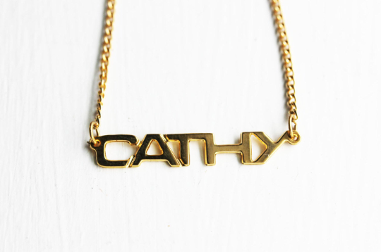 Vintage Cathy gold name necklace from Diament Jewelry, a gift shop in Washington, DC.