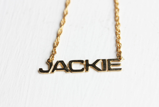 Vintage Jackie gold name necklace from Diament Jewelry, a gift shop in Washington, DC.