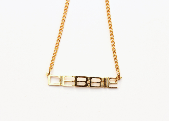 Vintage Debbie gold name necklace from Diament Jewelry, a gift shop in Washington, DC.