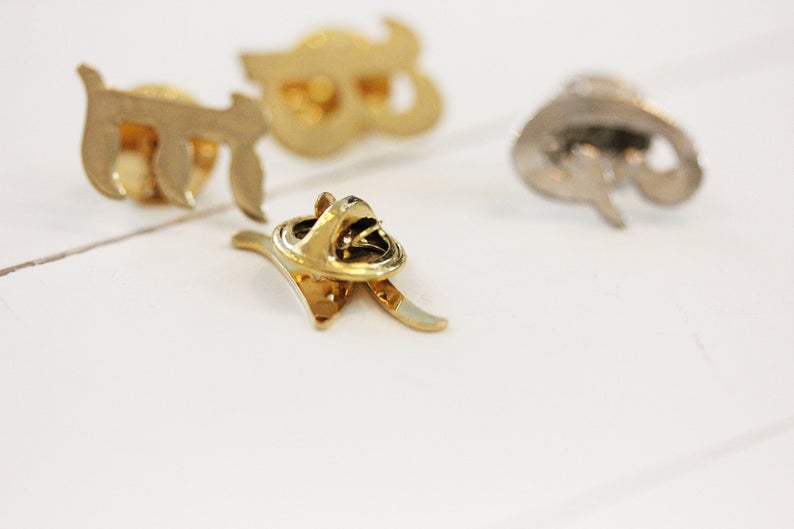 Gold and Silver Plated Initial Pins from Diament Jewelry, a gift shop in Washington, DC.