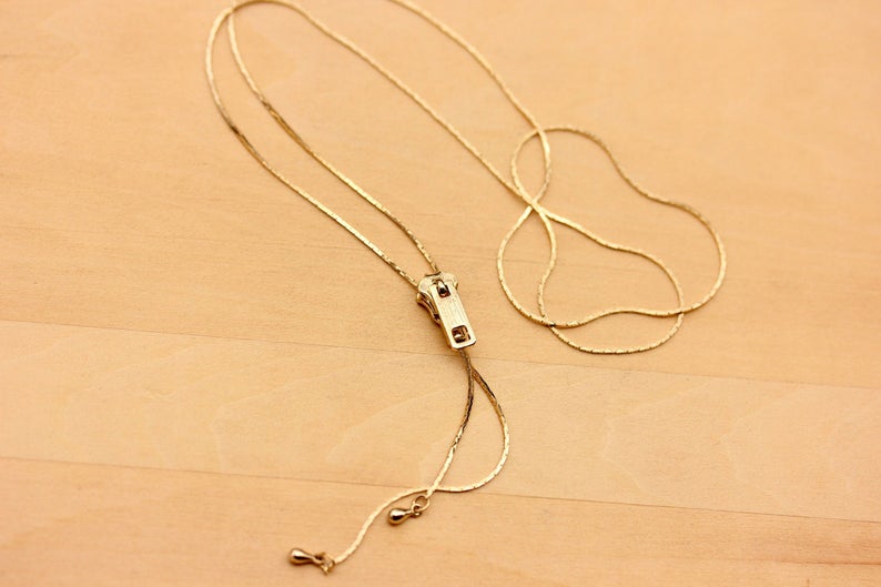 Gold Zipper Necklace from Diament Jewelry, a gift shop in Washington, DC.