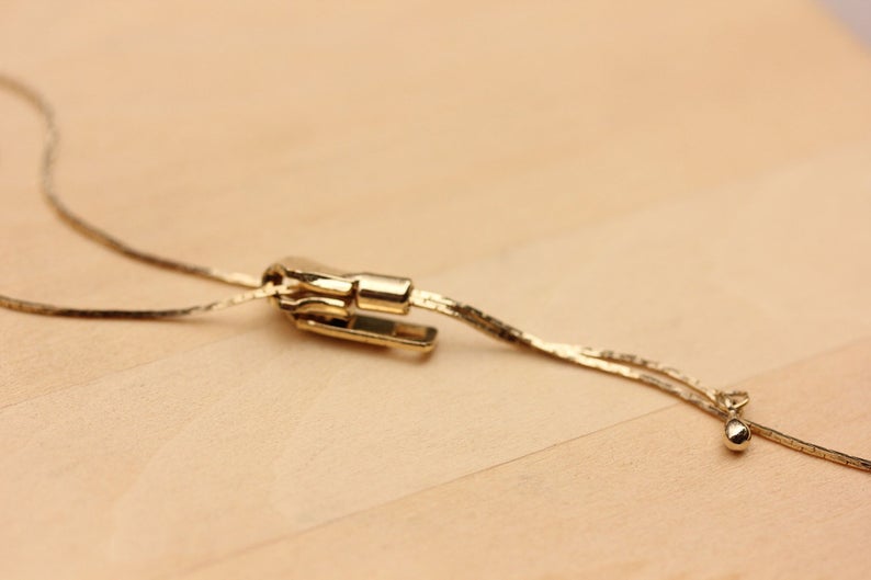 Gold Zipper Necklace from Diament Jewelry, a gift shop in Washington, DC.