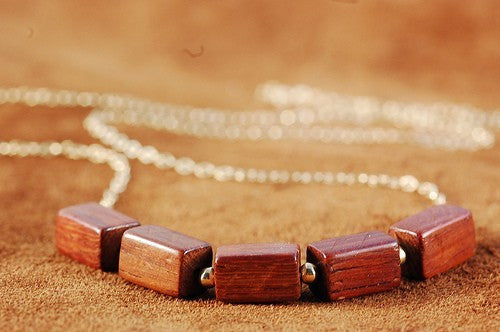 Beaded gold wood necklace from Diament Jewelry, a gift shop in Washington, DC.
