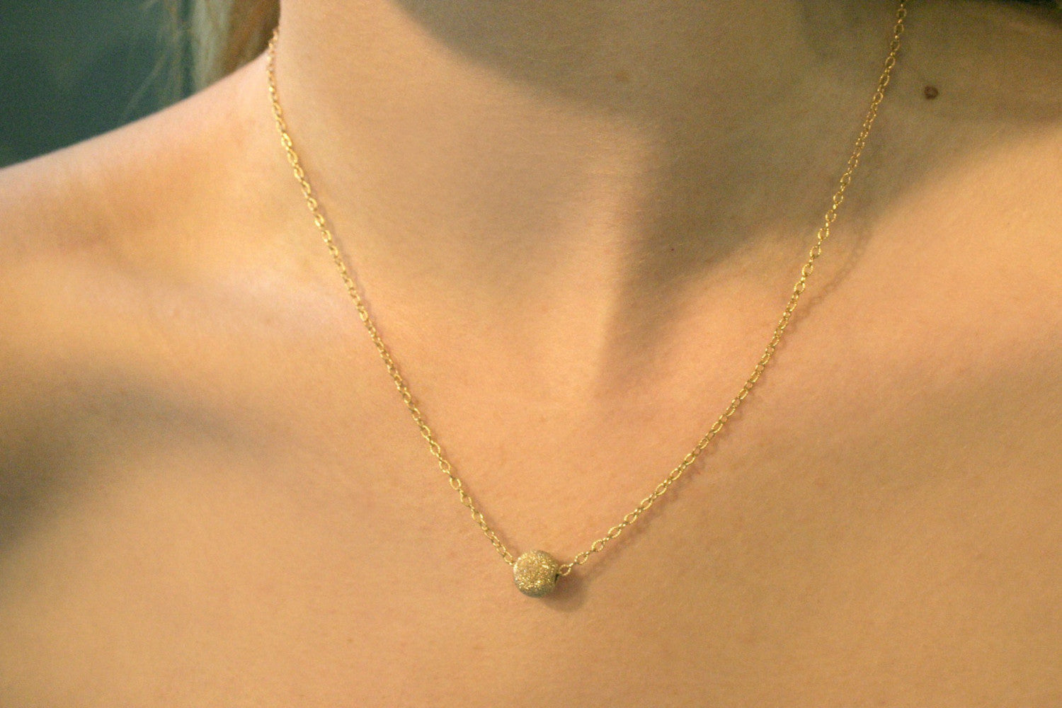 Gold chain with ball 2025 pendant