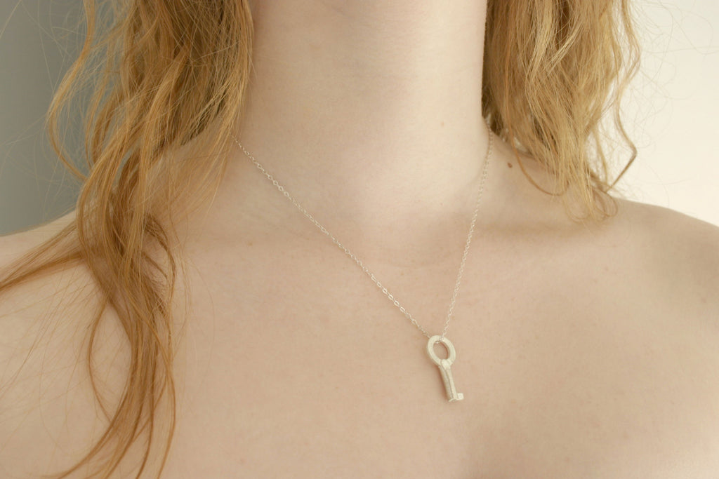 Small silver key necklace from Diament Jewelry, a gift shop in Washington, DC.