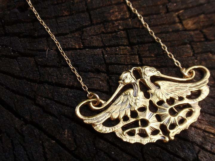Twin falcons gold necklace from Diament Jewelry, a gift shop in Washington, DC.