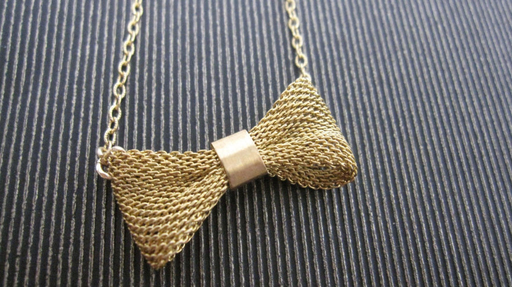 Gold mesh bow necklace from Diament Jewelry, a gift shop in Washington, DC.