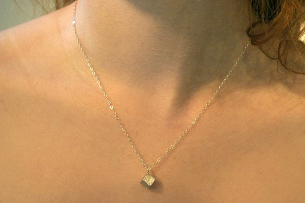 Gold cube necklace from Diament Jewelry, a gift shop in Washington, DC.