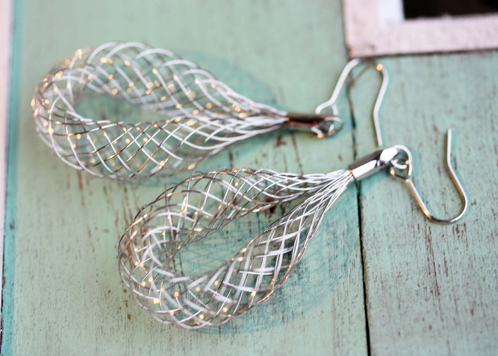 Silver whisk dangle earrings from Diament Jewelry, a gift shop in Washington, DC.
