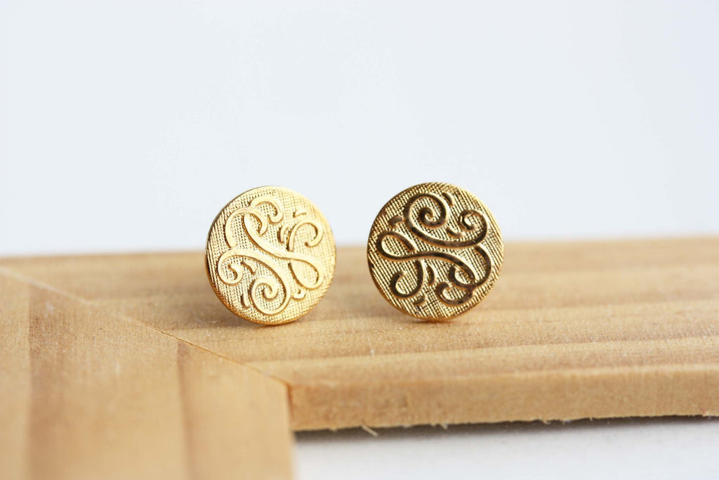 Gold swirl circle studs from Diament Jewelry, a gift shop in Washington, DC.