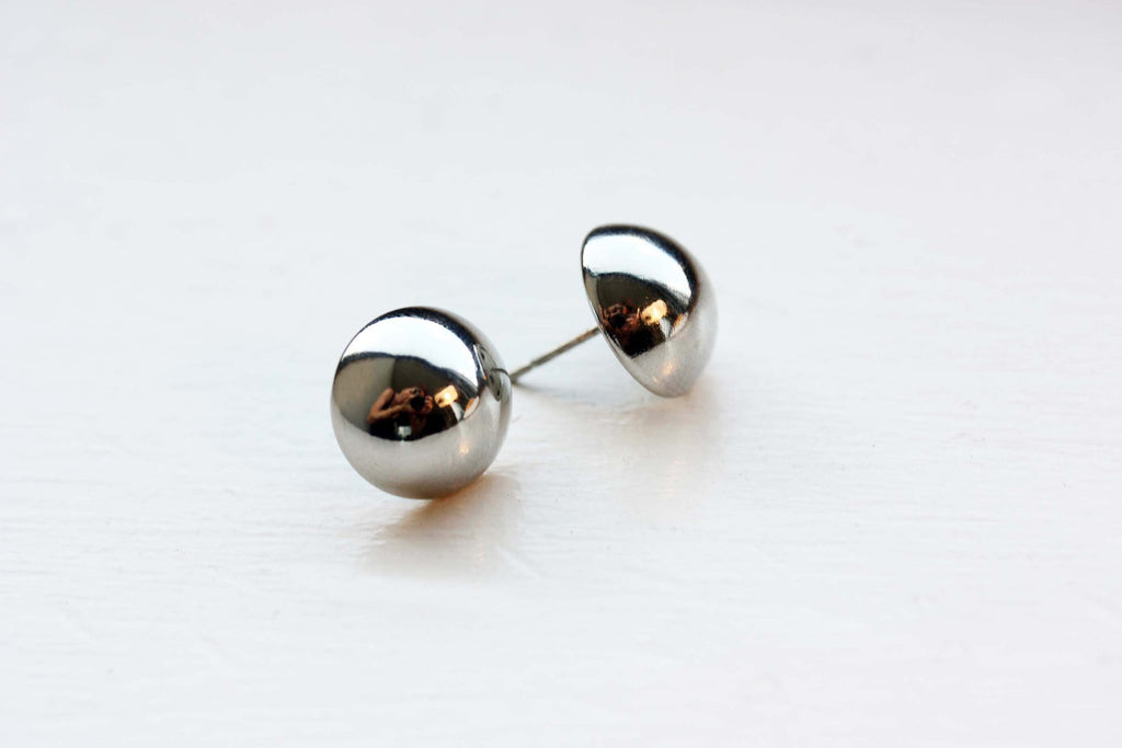 Large silver dome studs from Diament Jewelry, a gift shop in Washington, DC.