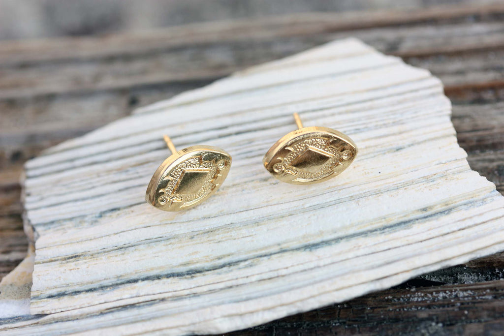 Small vintage gold oval studs from Diament Jewelry, a gift shop in Washington, DC.