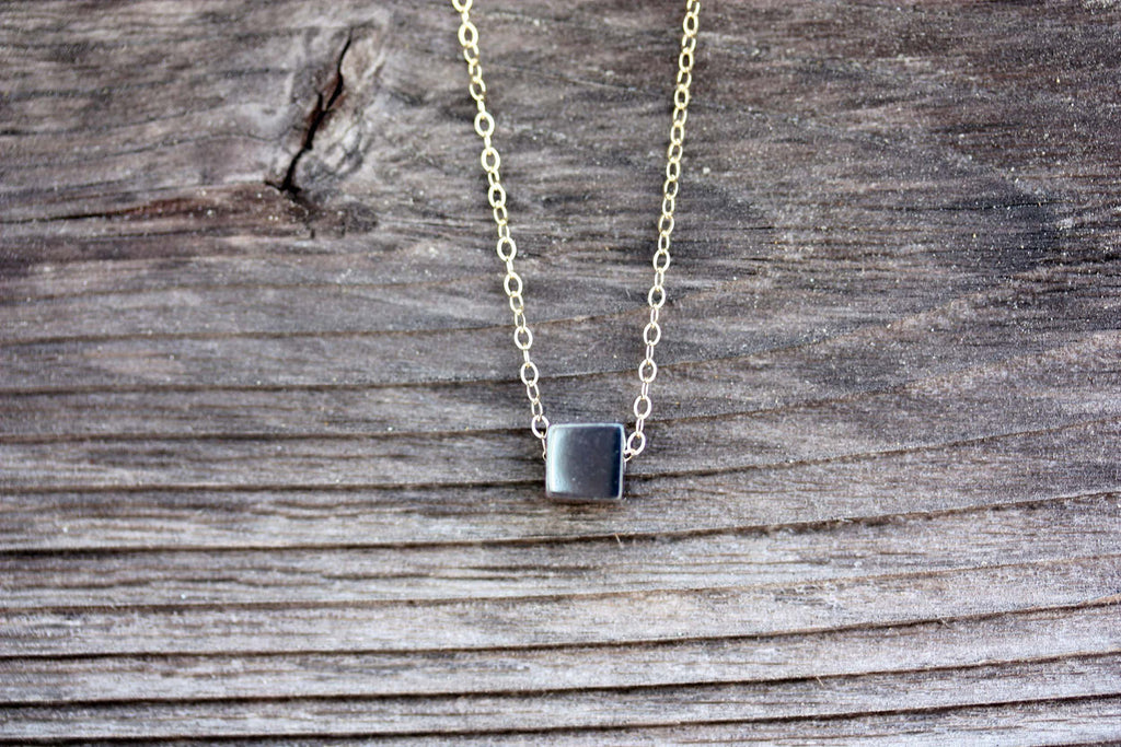 Silver and gold cube necklace from Diament Jewelry, a gift shop in Washington, DC.