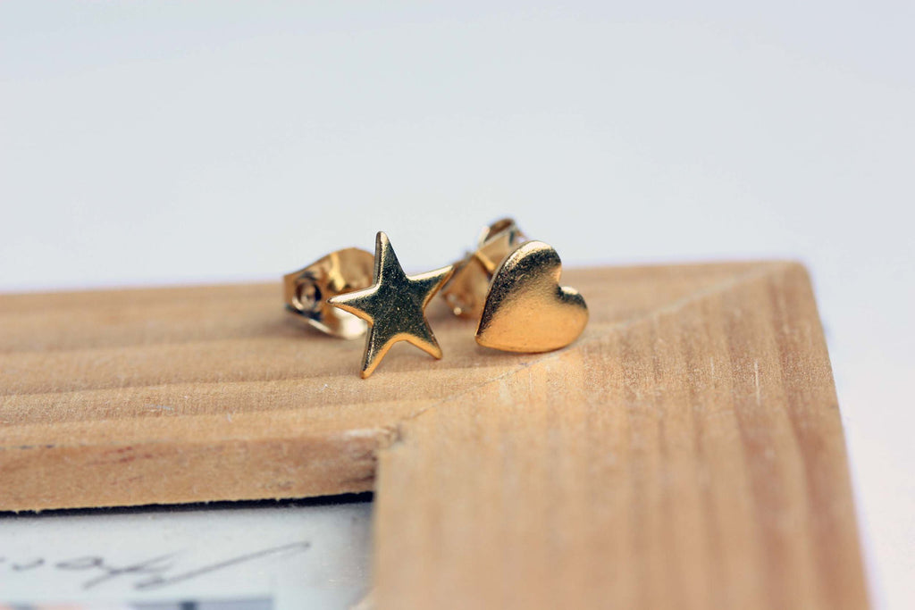 Mismatched gold heart and star studs from Diament Jewelry, a gift shop in Washington, DC.