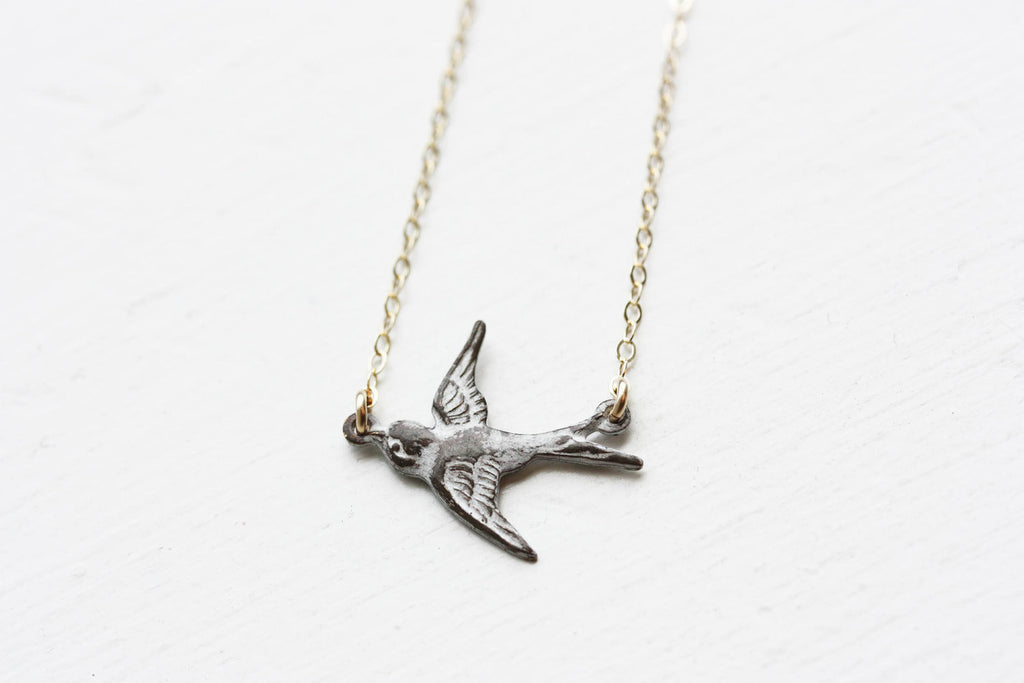 Tiny White Sparrow Necklace from Diament Jewelry, a gift shop in Washington, DC.