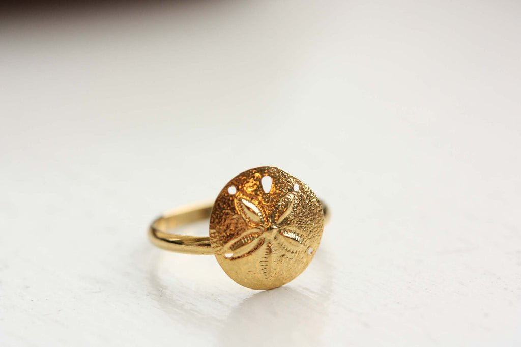 Gold sand dollar ring from Diament Jewelry, a gift shop in Washington, DC.