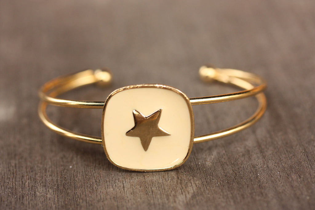 White and gold star cuff from Diament Jewelry, a gift shop in Washington, DC.
