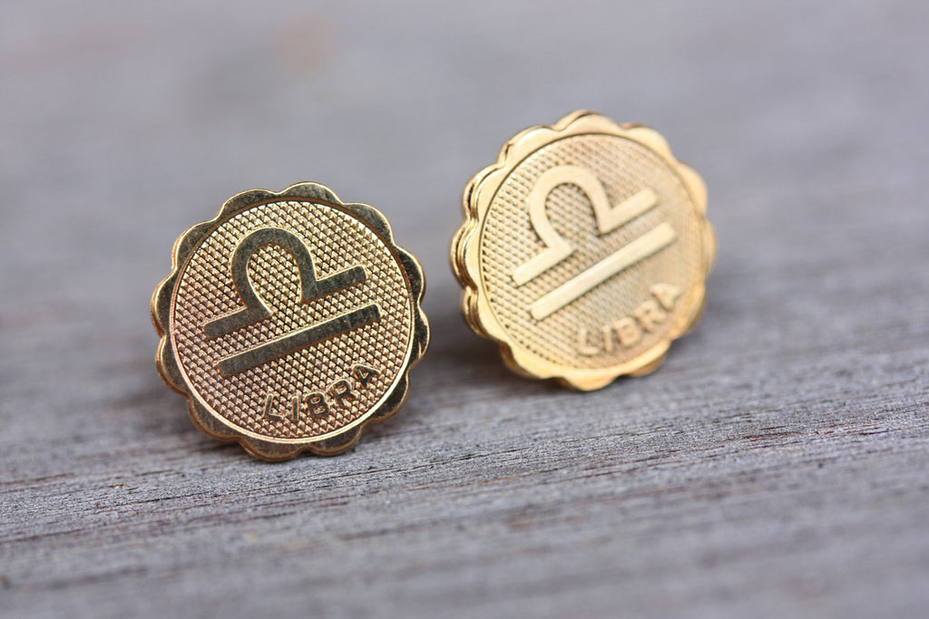 Gold Libra astrology studs from Diament Jewelry, a gift shop in Washington, DC.