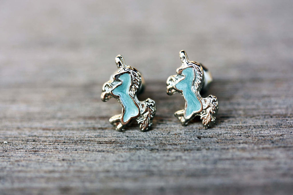 Blue and silver unicorn studs from Diament Jewelry, a gift shop in Washington, DC.