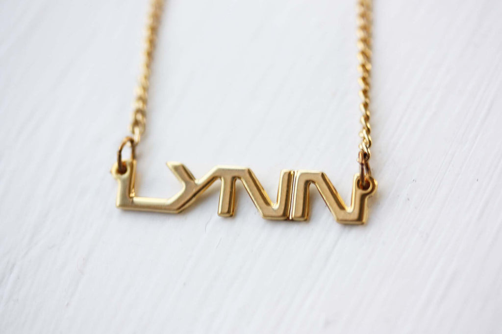 Vintage Lynn gold name necklace from Diament Jewelry, a gift shop in Washington, DC.