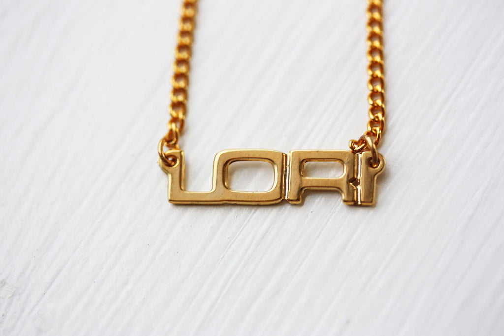 Vintage Lori gold name necklace from Diament Jewelry, a gift shop in Washington, DC.