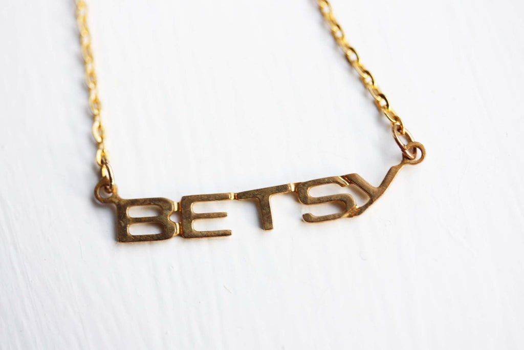 Vintage Betsy gold name necklace from Diament Jewelry, a gift shop in Washington, DC.