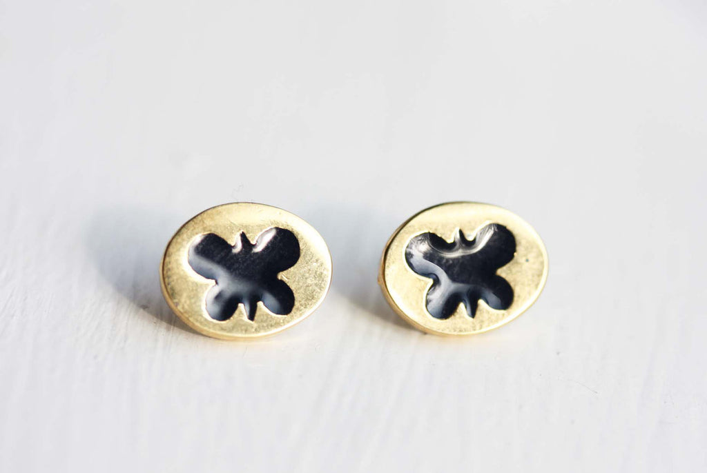 Gold and navy butterfly studs from Diament Jewelry, a gift shop in Washington, DC.