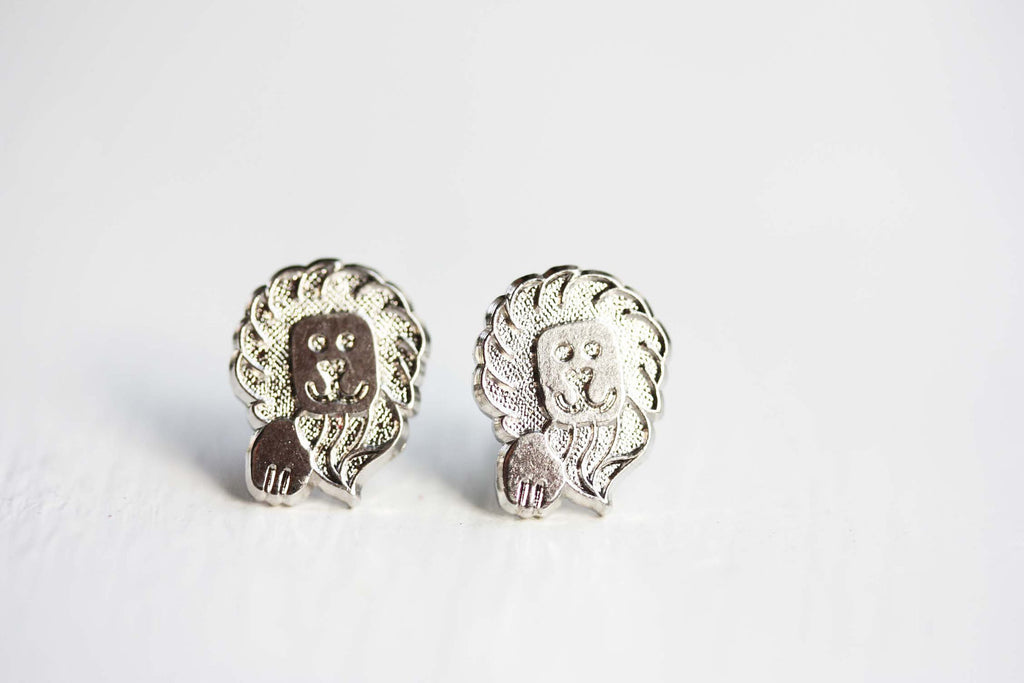 Silver lion studs from Diament Jewelry, a gift shop in Washington, DC.