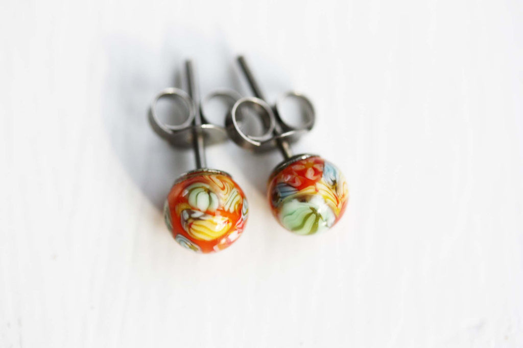 Orange confetti ball studs from Diament Jewelry, a gift shop in Washington, DC.