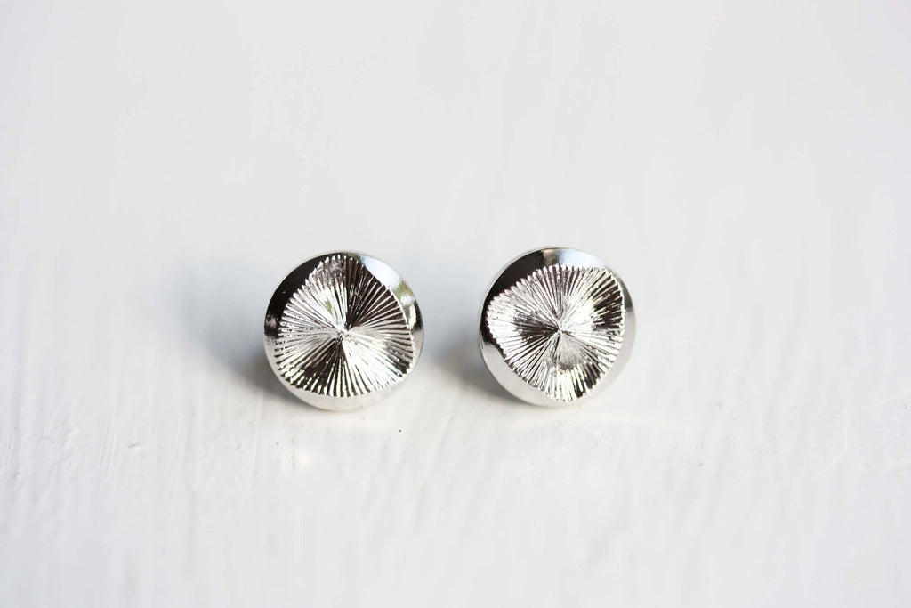 Silver disc studs from Diament Jewelry, a gift shop in Washington, DC.