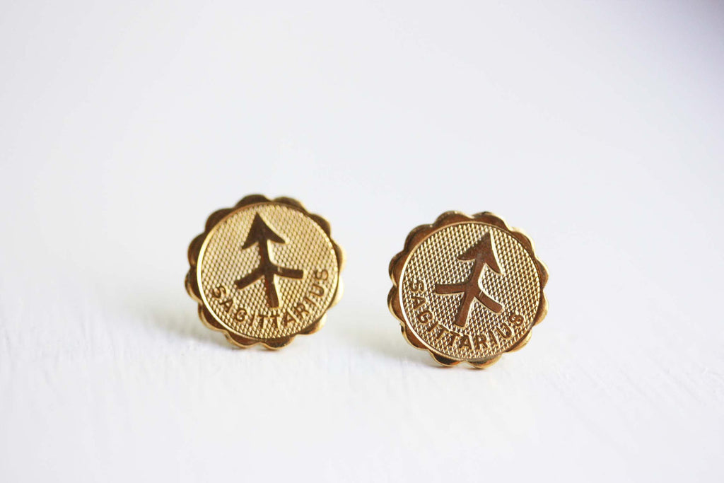 Gold Sagittarius astrology studs from Diament Jewelry, a gift shop in Washington, DC.