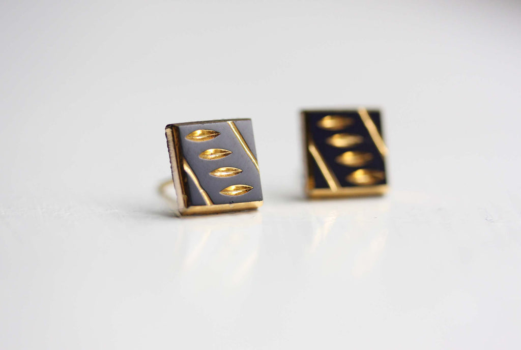 Black and gold dash studs from Diament Jewelry, a gift shop in Washington, DC.