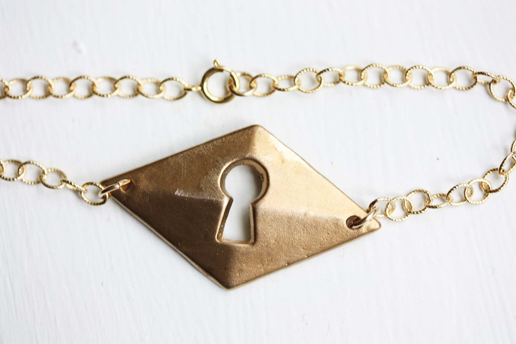 Brass keyhole bracelet from Diament Jewelry, a gift shop in Washington, DC.