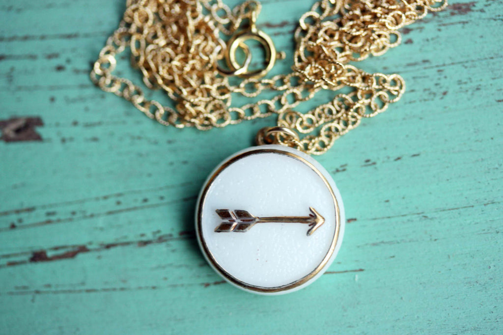 White and gold arrow necklace from Diament Jewelry, a gift shop in Washington, DC.