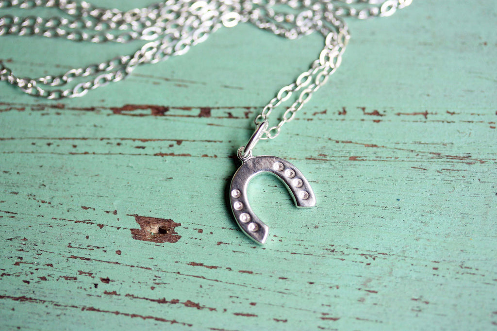 Silver horseshoe necklace from Diament Jewelry, a gift shop in Washington, DC.