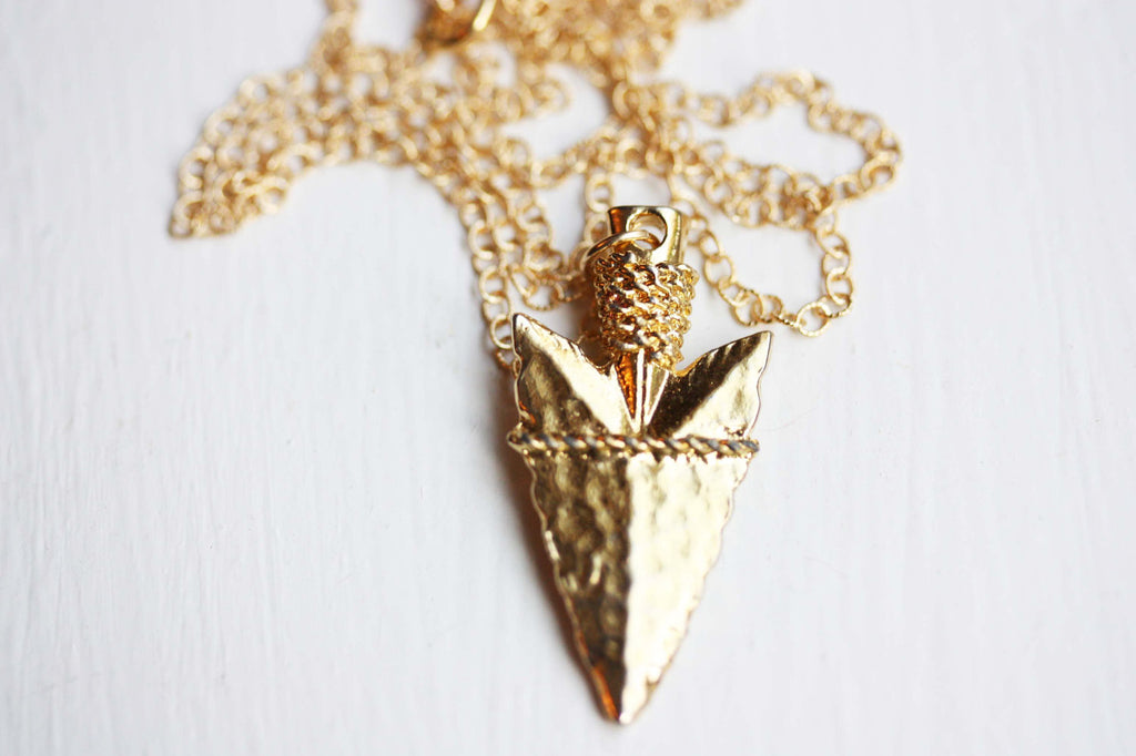 Gold arrowhead necklace from Diament Jewelry, a gift shop in Washington, DC.