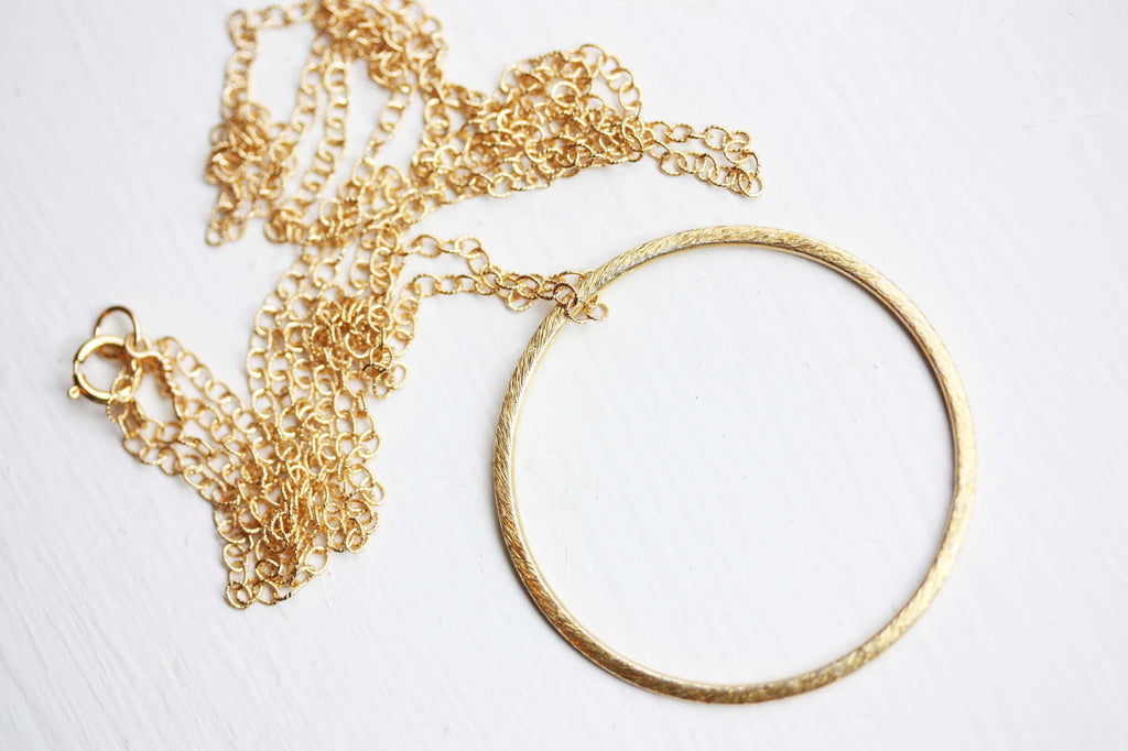 Long gold circle necklace from Diament Jewelry, a gift shop in Washington, DC.